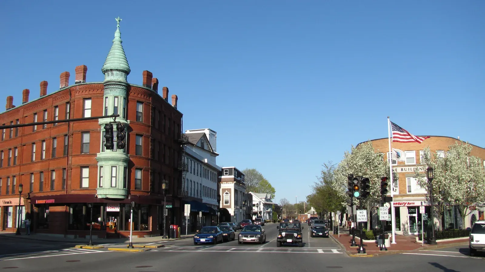 Historic brick commercial block with a copper corner turret in Medford Square, Medford, Massachusetts