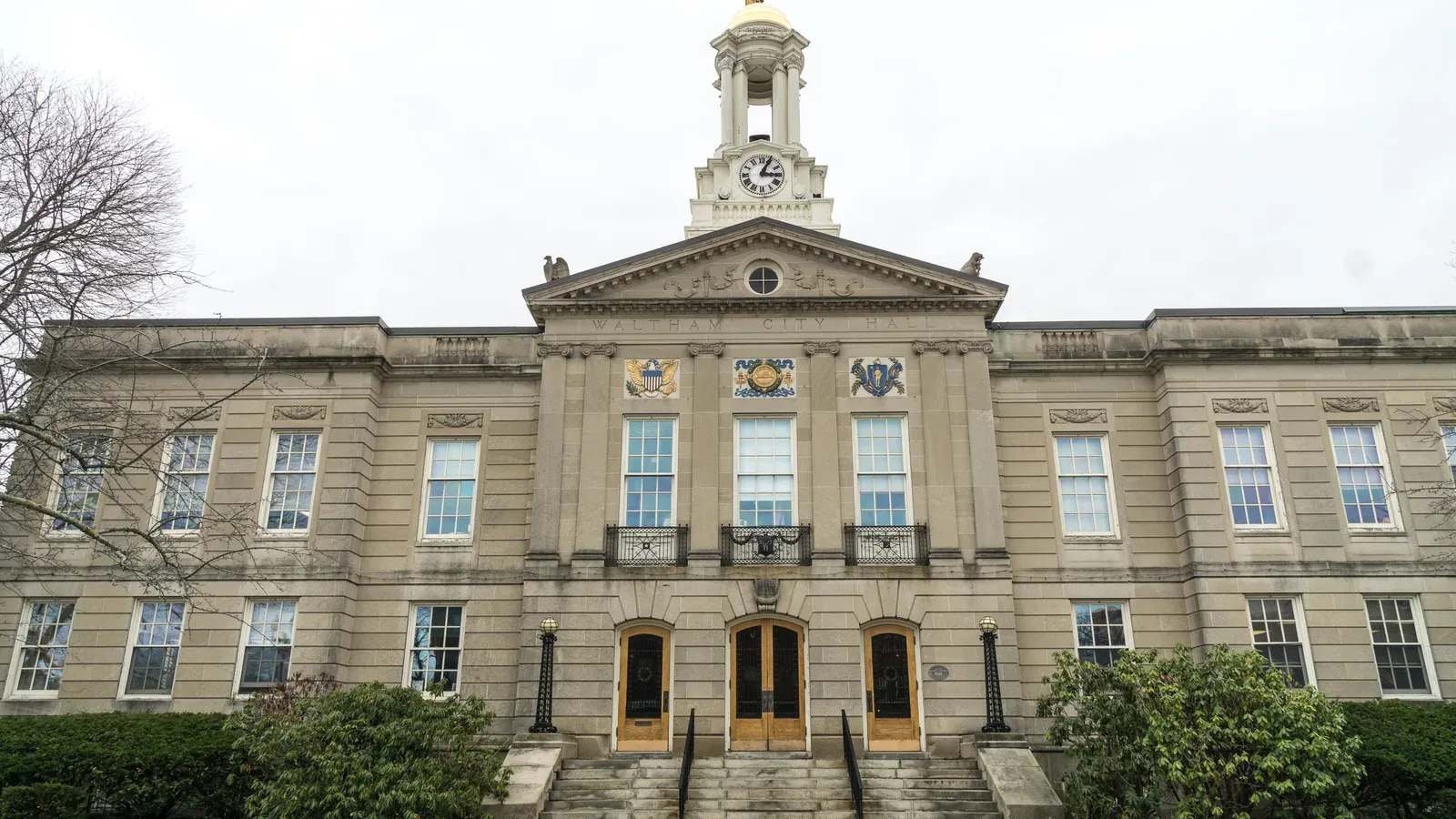 Waltham City Hall, a stone Classical Revival building with a domed clock cupola, Waltham, Massachusetts