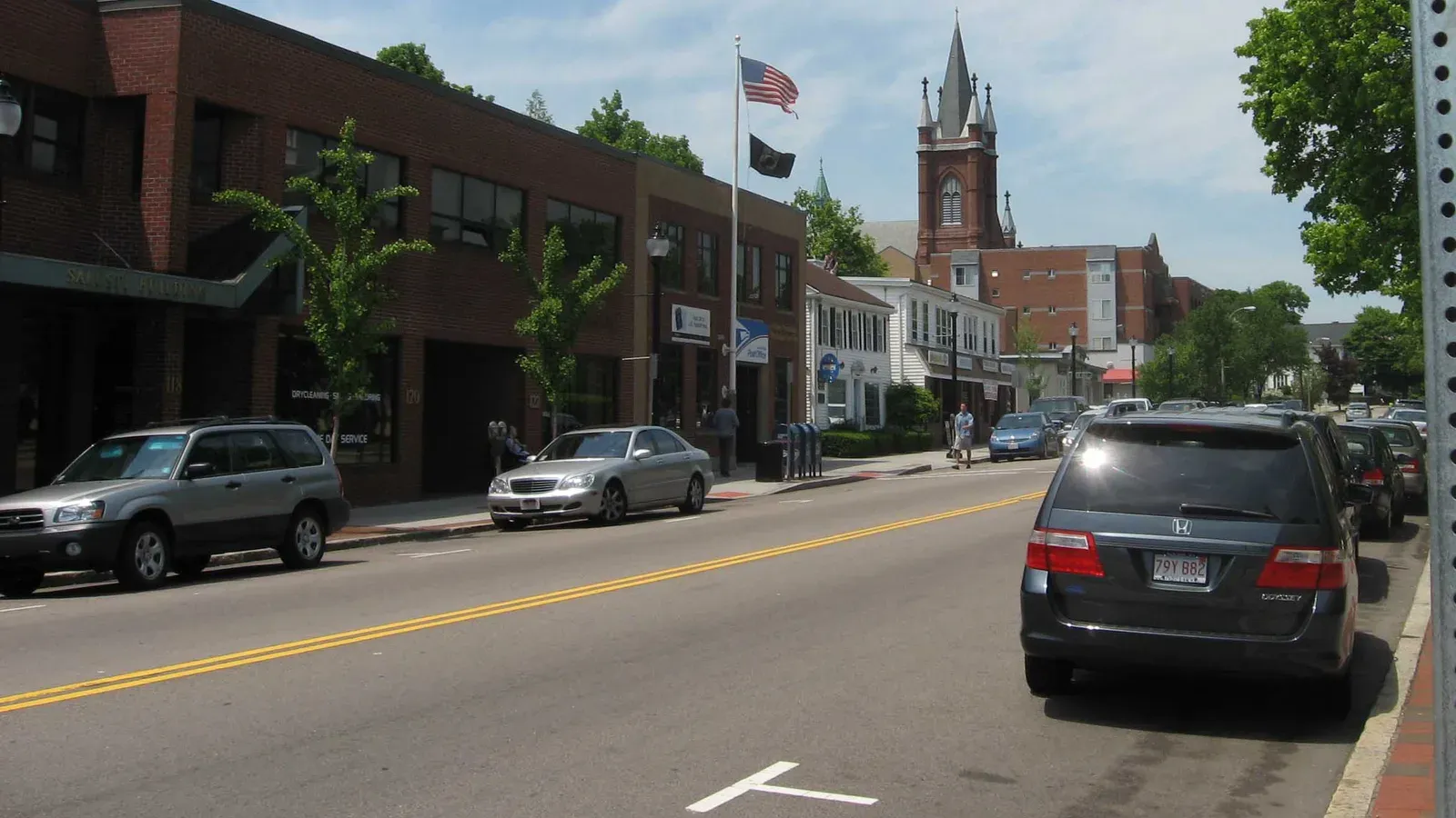 Main Street commercial district with a brick church steeple, Watertown, Massachusetts